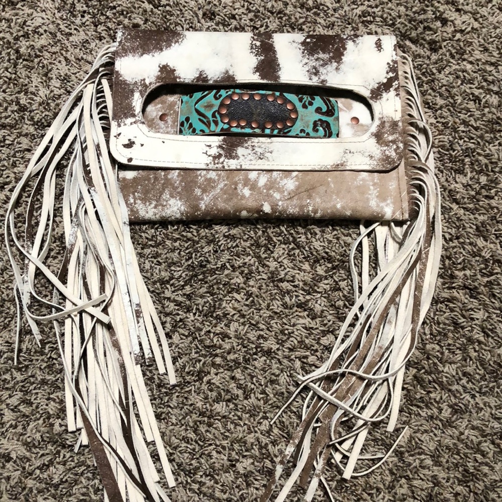 Hand made genuine leather clutch.